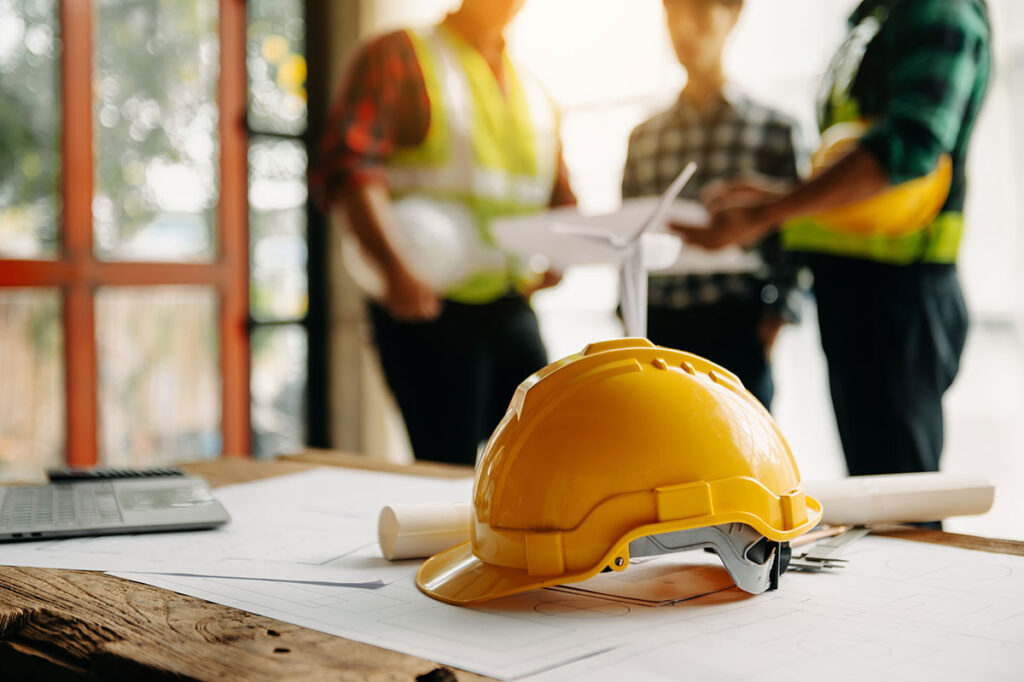 construction hat on table with team in background