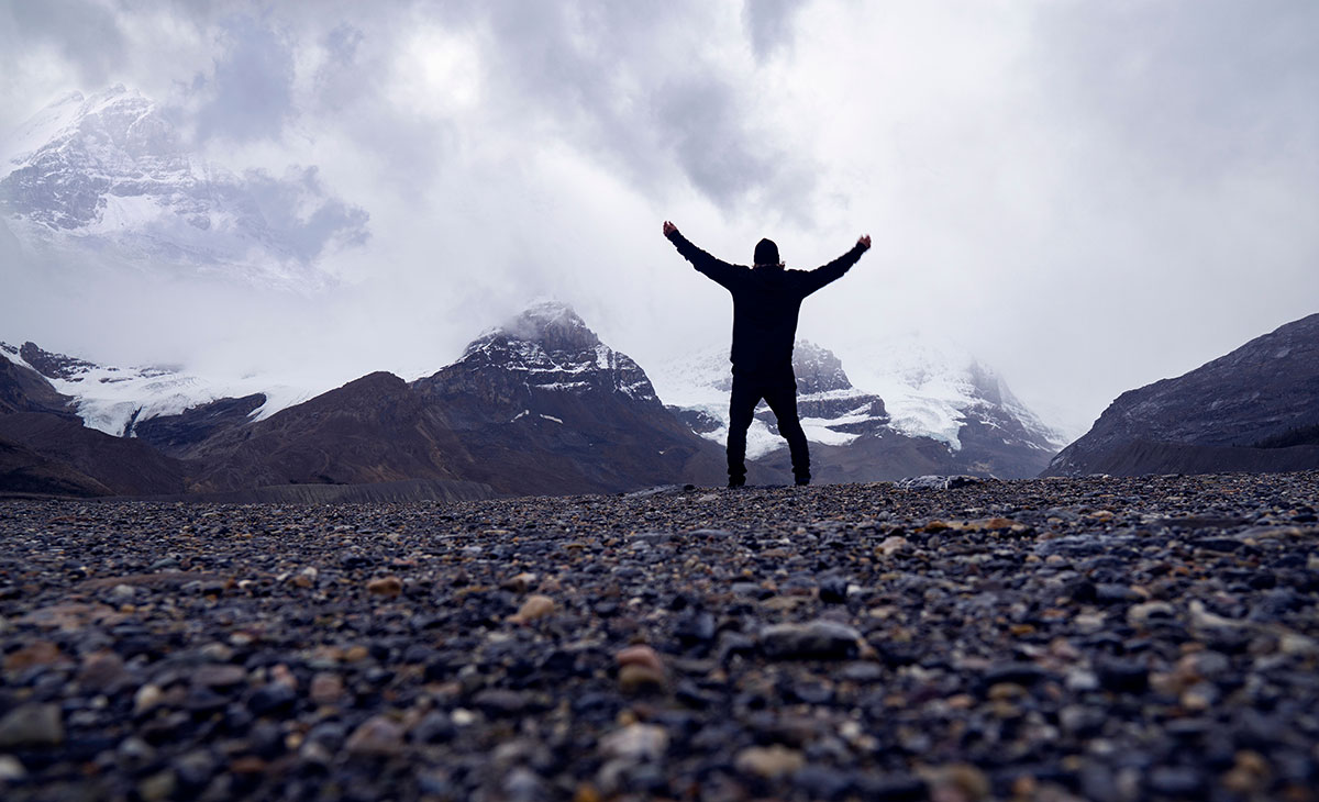 man celebrating mountain climb